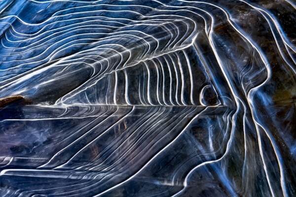 By Michael Piraino Abstract ice patterns in Merced River Yosemite National Park