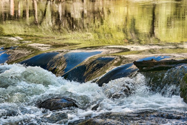 By Carin Piraino Autumn reflections in river rapids in Yosemite National Park