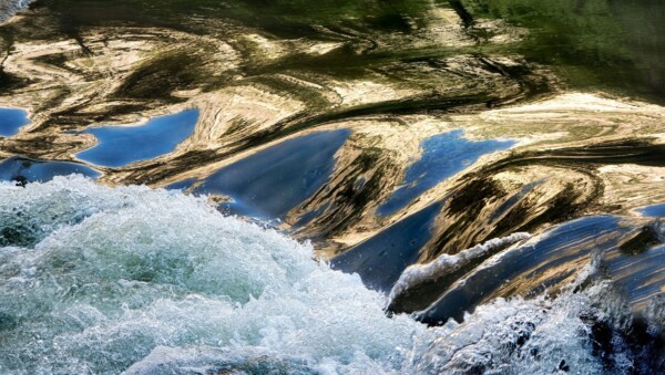 By Carin Piraino Abstract closeup river rapids in Yosemite National Park