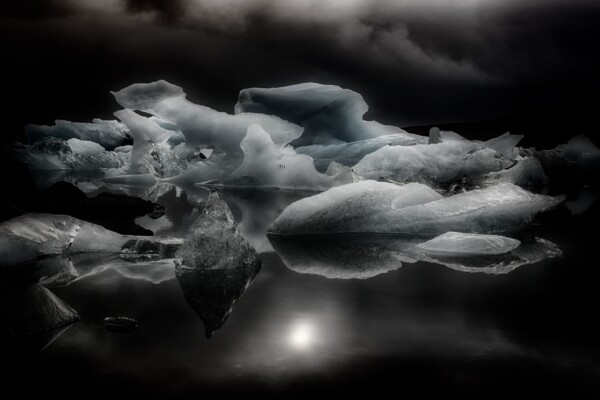 By Michael Piraino Moon and icebergs on glacial lagoon at night in Iceland