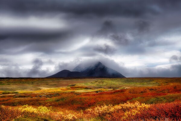 By Michael Piraino Volcano with clouds and fall foliage, Iceland