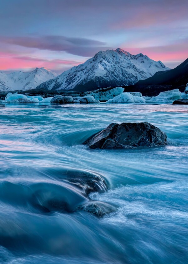 By Michael Piraino Glacial lake in Southern Alps with icebergs at sunrise, south island New Zealand