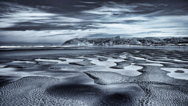 By Michael Piraino Tidepools with mountains and clouds, Oregon coast, monochrome