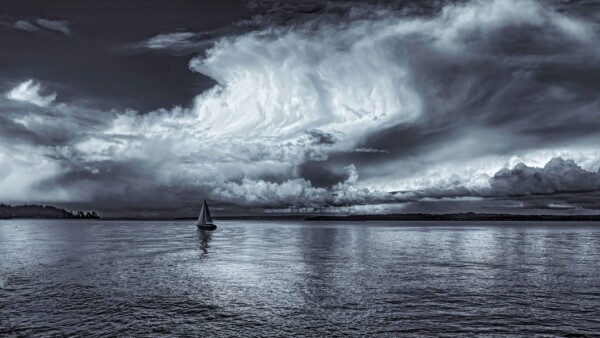 By Michael Piraino Storm cloud over puget sound with sailboat