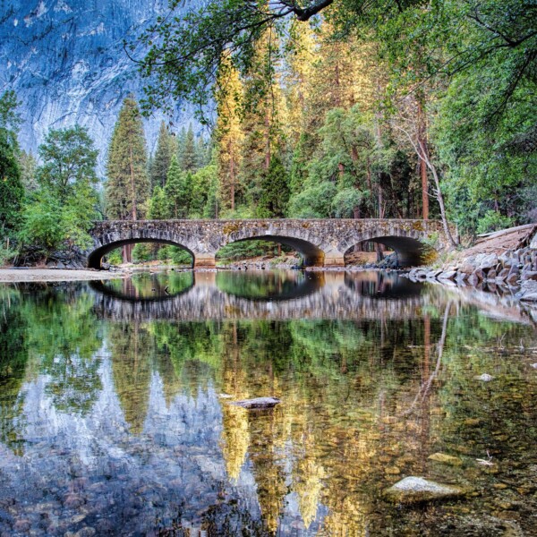 By Michael Piraino Reflections of the Ahwahnee bridge in the Merced River Yosemite Valley