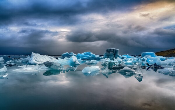 By Michael Piraino Sunrise over blue icebergs in glacial lagoon, Iceland