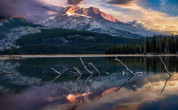 By Michael Piraino Sunrise over Oregon mountain peak with lake reflections