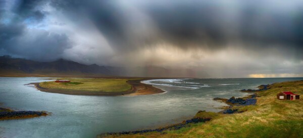 By Michael Piraino Panorama of river, mountains and clouds at sunrise in Iceland