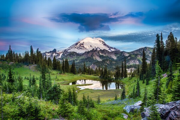 By Michael Piraino Clouds at sunrise above a small lake in Mount Rainier National Park