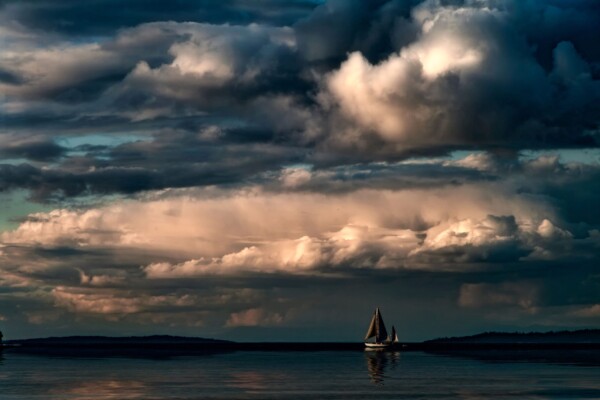 By Michael Piraino Sunset, clouds and sailboat on Puget Sound