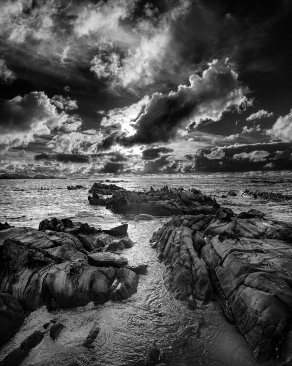 By Michael Piraino Sunset with rocks and surf on the coastline of the Southern Ocean in Tasmania