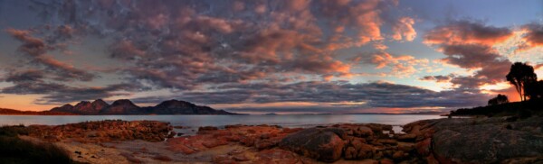 By Michael Piraino Sunset panorama of the Hazard Mountains in Tasmania with red foreground rocks