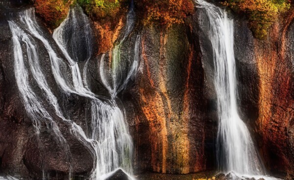 By Michael Piraino lava field volcano and waterfalls with red and gold rock