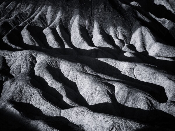 By Michael Piraino black and white abstract curves at badlands in Death Valley